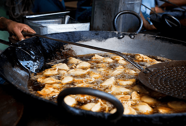 Samosas, Indian appetizers, stuffed pastry, deep-fried snacks, crispy texture, culinary heritage, street food, international fusion, food culture.