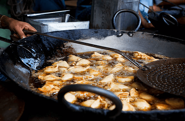 Samosas, Indian appetizers, stuffed pastry, deep-fried snacks, crispy texture, culinary heritage, street food, international fusion, food culture.